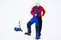 Side zips undo fully (at the top). No need to remove boots/crampons.